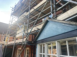 scaffolding covered the back of a building that requires restoration