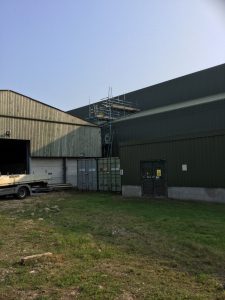 scaffolding for roof access to a large barn on a farm