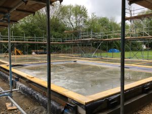 scaffolding surrounding a building foundation for construction