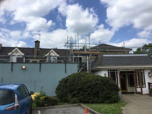 scaffolding equipment on the side and on the roof of building