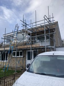 Bungalow with scaffolding equipment on the front