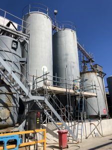 scaffolding on side of commercial storage tanks - image 1