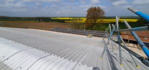 Scaffolding on top of a barn for a solar installation in Alford